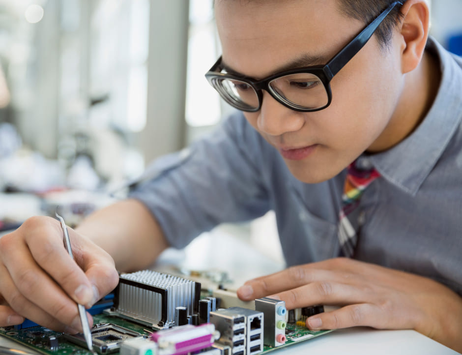 Boy working with the hardware of a computer