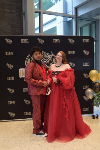 Students wearing red dress and a red suit at their prom