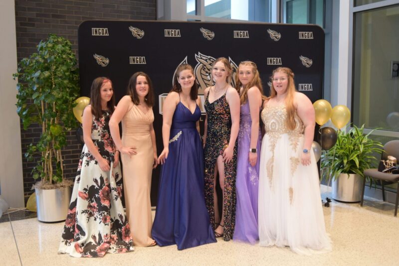 Students at their prom wearing dresses
