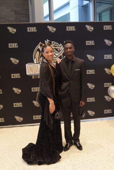 Student attending to their prom together wearing a black dress and a black suit