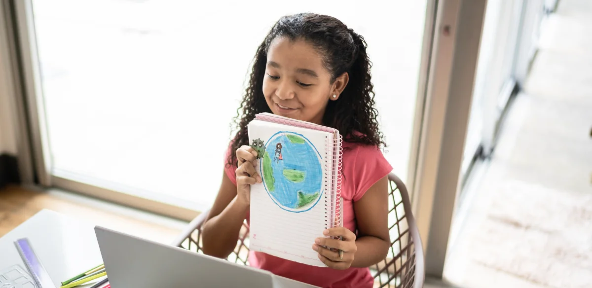 girl holding a notebook with a map