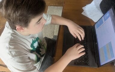 boy writing in the computer