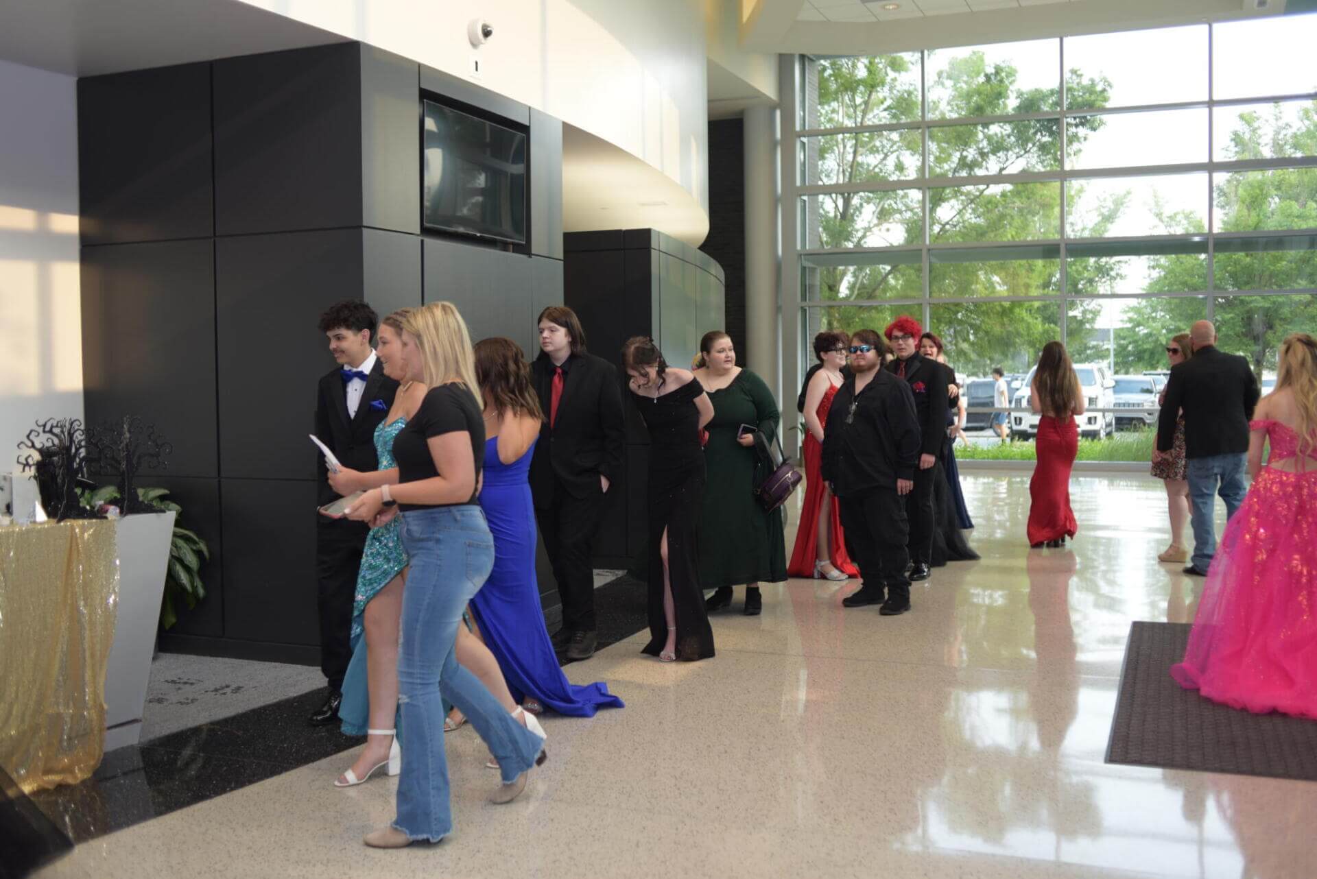 People arriving at a prom dance