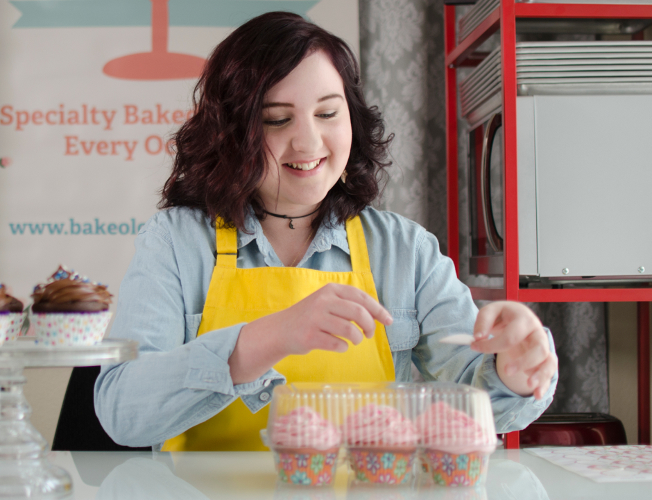 Baker woman preparing cupcakes
