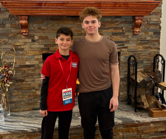 Scholastic Kid Reporter Asher Freije with speed skater Quinn Derheimer.