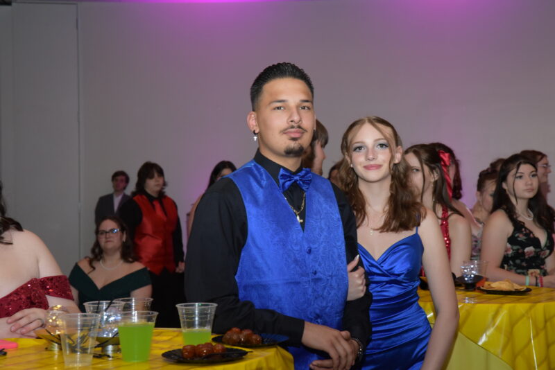 students smiling with blue dresses