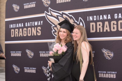 students smiling at the graduation